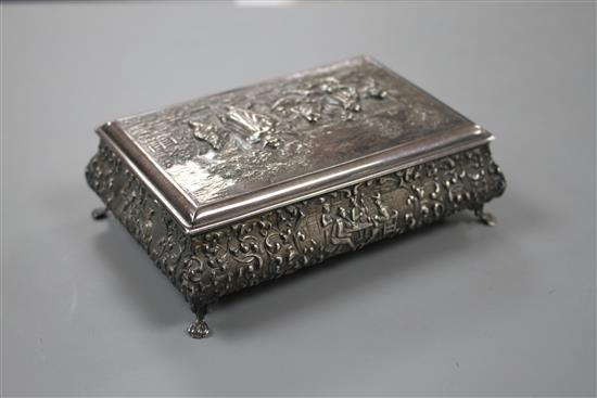 A 20th century continental embossed white metal rectangular bombe shaped cigarette? box, with wood lined interior, 14cm